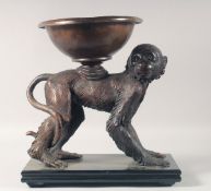A BRONZE GROUP OF A MONKEY WITH A BOWL ON HIS BACK, standing on a marble base. 14.5ins long.