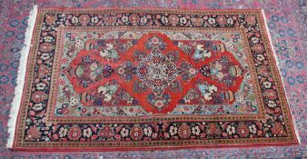 A GOOD PERSIAN CARPET, rust ground with vases of flowers and floral border. 7'2