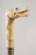 A WALKING STICK WITH CARVED BONE HANDLE as an alligator.