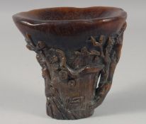 A CHINESE CARVED HORN LIBATION CUP. 5.25ins high.