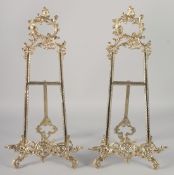A PAIR OF ORNATE BRASS EASELS 21ins high.