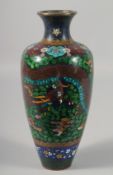 A JAPANESE CLOISONNE VASE decorated with a dragon. 10.5ins high.