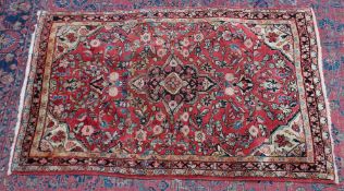 A PERSIAN RUG, pale red ground with all over stylised floral design. 5'5