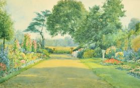 Henry John Sylvester Stannard (1870-1951) British, A view of a beautiful summer garden in bloom, a