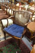 A mahogany armchair with cane work back and seat.