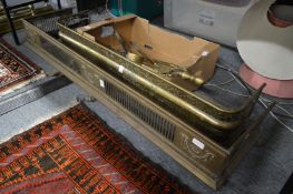 Two brass fenders and various fireside tools.