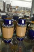 Two Royal Doulton jugs, one cracked.