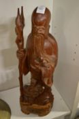 A Chinese carved wood standing figure of a sage.