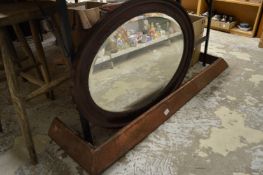 An oval mirror and a copper fender.