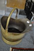 A brass coal scuttle.