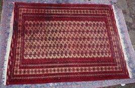 A large Persian Bokhara carpet, beige ground with five rows of twenty two gulls 9'10