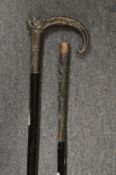 A French silver handled ebony walking cane and similar parasol.