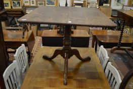 An oak tilt top tripod breakfast table.