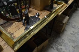 An adjustable brass fender.