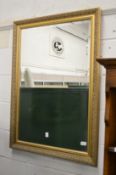 A gilt framed mirror.