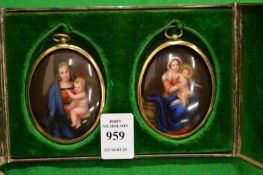 A pair of Continental miniature porcelain oval paintings depicting the Madonna and child in a plated