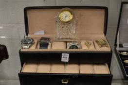 A Waterford crystal bedside clock, various watches and a watch case.