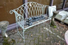 A small wrought iron garden bench.