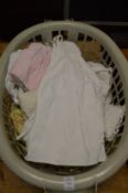 A quantity of linen, lace and other textiles to include a christening gown.