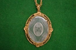 A rock crystal pendant with gilt metal frame and necklace.