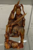 A Chinese carved horn figure on horse back.