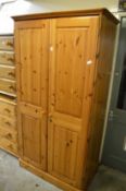 A pine two door wardrobe.