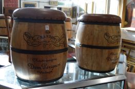 A pair of novelty barrel shaped bar stools with removable button upholstered tops.