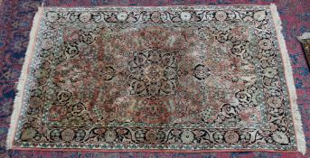 A Persian part silk rug, orange ground with stylised floral decoration 6' x 3'11