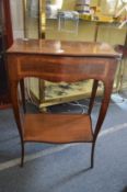 A mahogany and satinwood banded serpentine fronted two tier washstand with rising top.