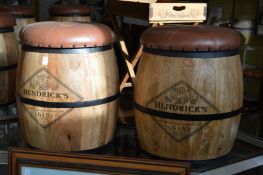 A pair of novelty barrel shaped bar stools with removable button upholstered tops.