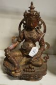 A Tibetan cast bronze seated deity with traces of gilding.