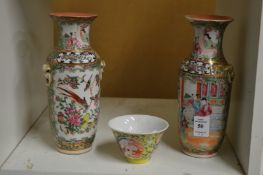 Two Chinese famille rose vases and a famille jaune tea bowl.