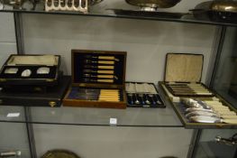 Cased plated flatware and various empty cutlery cases.