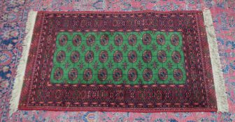 A modern Bokhara rug, bright green ground with three rows of nine gulls 5'2