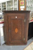 A 19th century oak hanging corner cupboard.