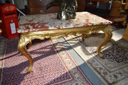 A marble topped gilt wood coffee table.