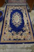 A blue ground floral decorated rug 7' x 4'.