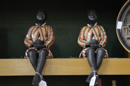 A pair of pottery seated figures.