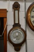 An oak cased barometer/thermometer.