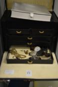 A jewellery box containing watches and a small amount of jewellery.