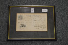 A framed and glazed Bank of England white five pound note.