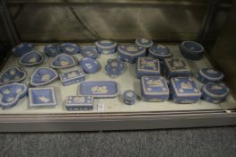 A collection of blue jasperware dishes and boxes.