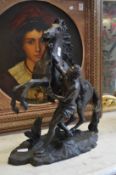 A large spelter model of a Marley horse and handler.