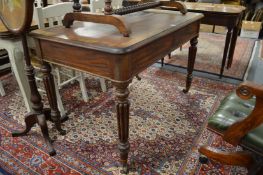 Gillows of Lancaster, a 19th century mahogany two drawer writing table on reeded turned tapering