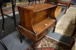 An oak double sided single drawer low book shelf.
