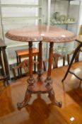 A trefoil shaped occasional table.