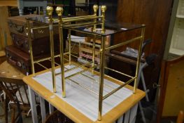 A pair of smoked glass and brass occasional tables.