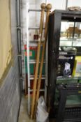 A long Victorian style wooden curtain pole in two halves compete with rings, 12ft 6
