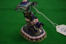 An Eastern enamelled silver group of figures in a howdah on a elephant.