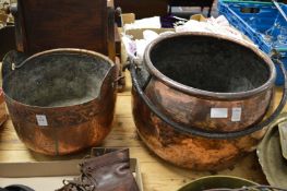 Two large copper cooking pots.